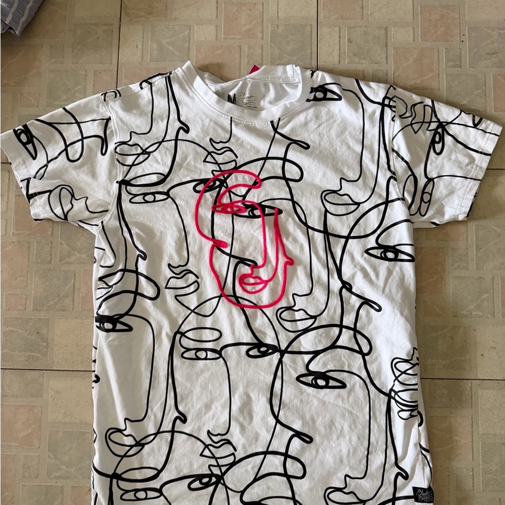 White Graphic Tee with Black Line Art and Pink Face Detail - Size Medium